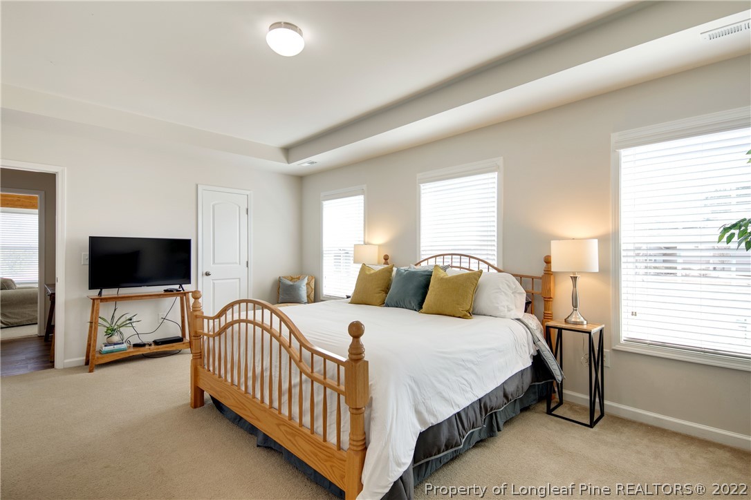 381 River Oaks St Spring Lake Spring Lake, NC 28390 - Photo 27 of 49 a bedroom with a bed and a flat screen tv