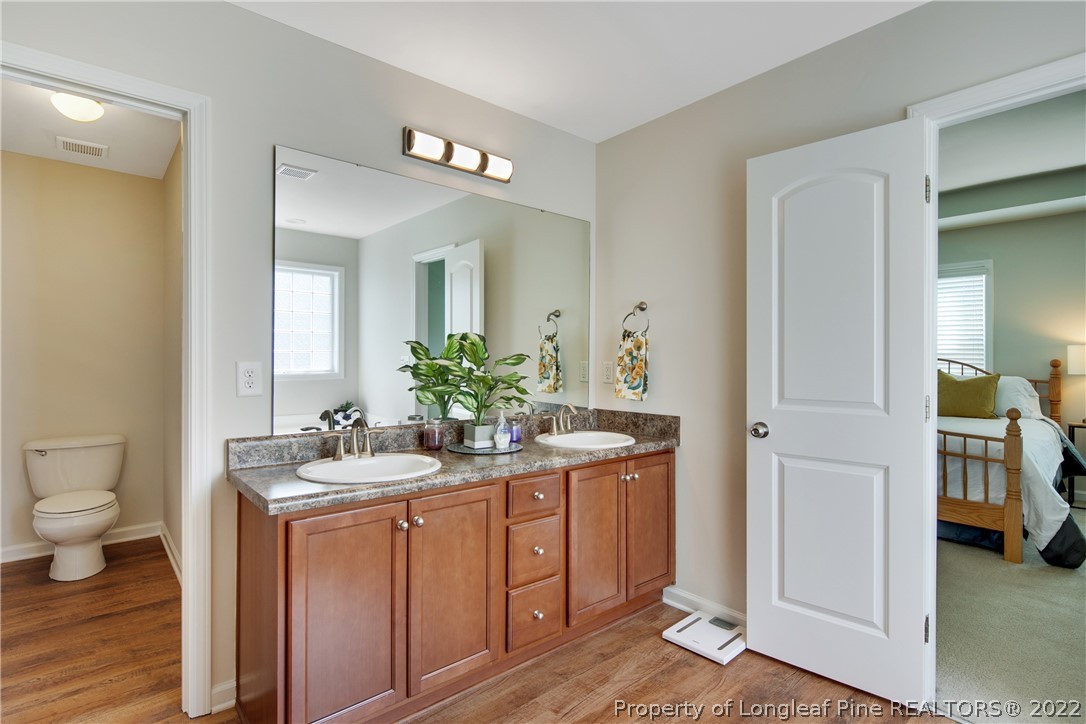 381 River Oaks St Spring Lake Spring Lake, NC 28390 - Photo 31 of 49 a spacious bathroom with a toilet sink and mirror
