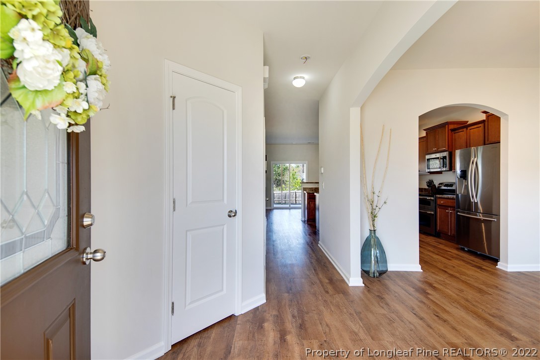 381 River Oaks St Spring Lake Spring Lake, NC 28390 - Photo 5 of 49 a view of a hallway with wooden floor and a potted plant