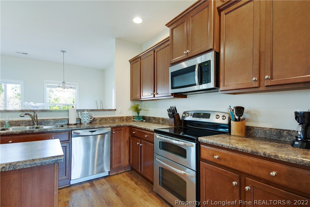 381 River Oaks St Spring Lake Spring Lake, NC 28390 - Photo 10 of 49 a kitchen with stainless steel appliances granite countertop a sink stove and microwave