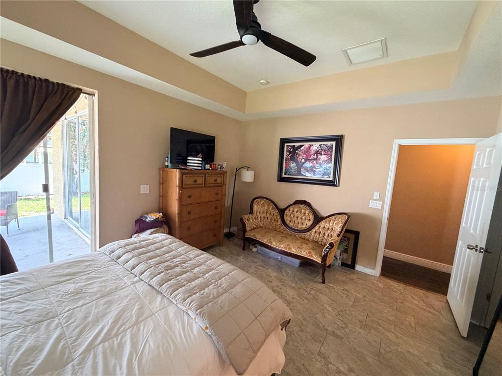 13250 Mandalay Place Spring Hill, FL 34609 - Photo 13 of 28 a bedroom with a bed and a flat screen tv