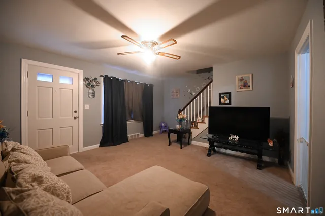 a bedroom with a bed and a flat tv screen on wall