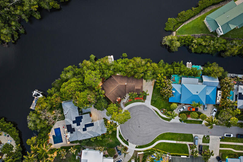 702 Warren Drive Jupiter, FL 33458 - Photo 71 of 76 an aerial view of a house with a yard and a garden