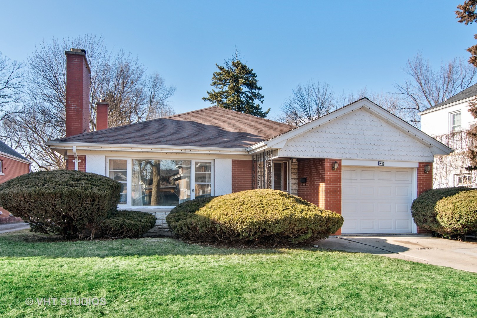 430 Longcommon Road Riverside, IL 60546 - Photo 1 of 20 a front view of a house with a garden