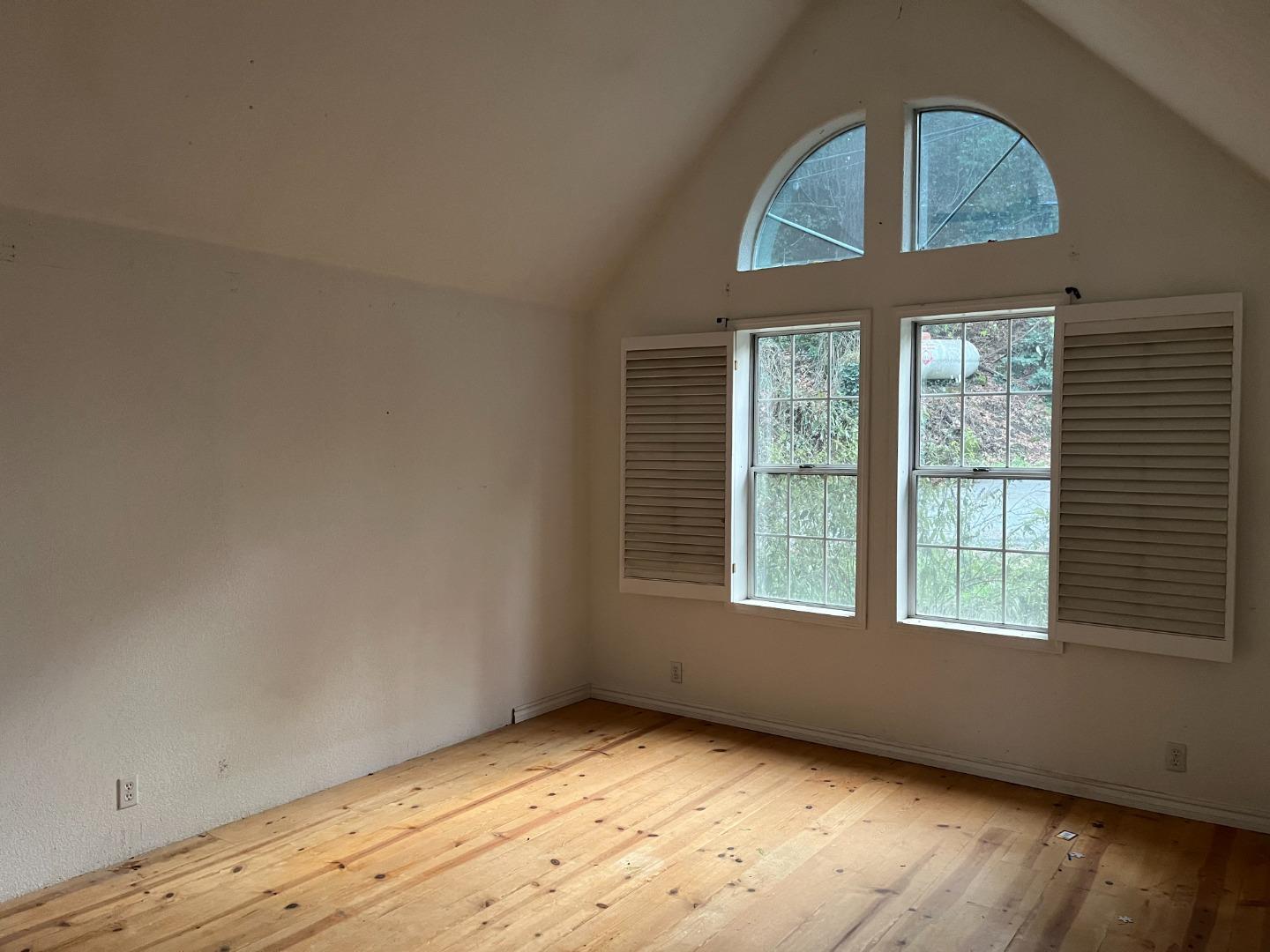 18165 Santa Ana Road Los Gatos, CA 95033 - Photo 11 of 14 an empty room with wooden floor fan and windows