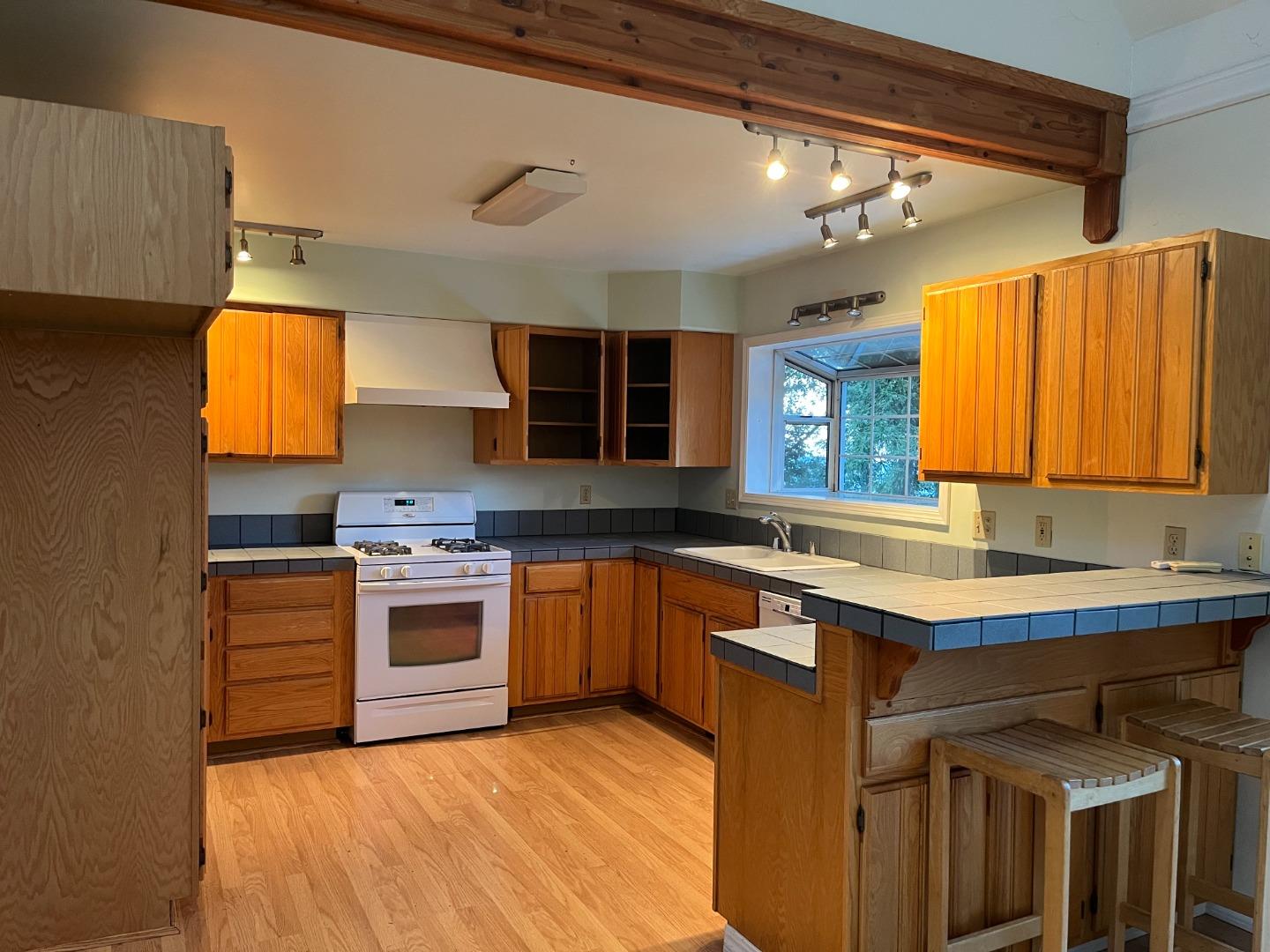18165 Santa Ana Road Los Gatos, CA 95033 - Photo 5 of 14 a kitchen with stainless steel appliances granite countertop a sink stove and cabinets