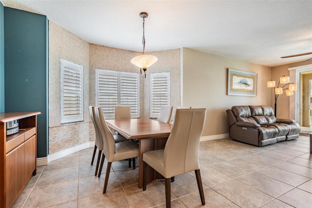399 150th Avenue, Unit 315 Madeira Beach, FL 33708 - Photo 11 of 53 a view of a dining room with furniture window and wooden floor