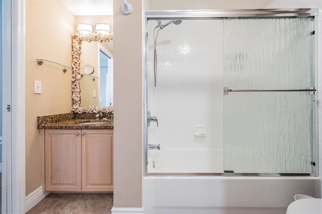 399 150th Avenue, Unit 315 Madeira Beach, FL 33708 - Photo 20 of 53 a bathroom with a shower and a sink