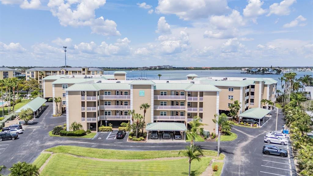 399 150th Avenue, Unit 315 Madeira Beach, FL 33708 - Photo 39 of 53 a view of a swimming pool and outside seating area