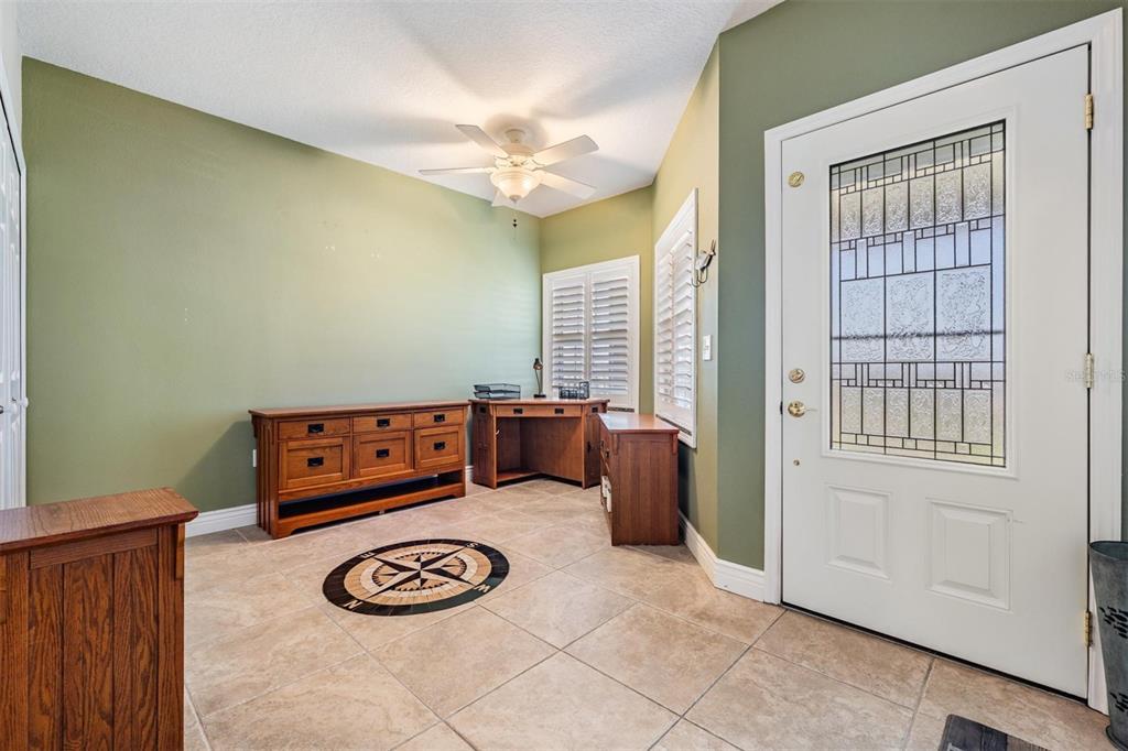 399 150th Avenue, Unit 315 Madeira Beach, FL 33708 - Photo 4 of 53 a view of entryway with a window and wooden floor
