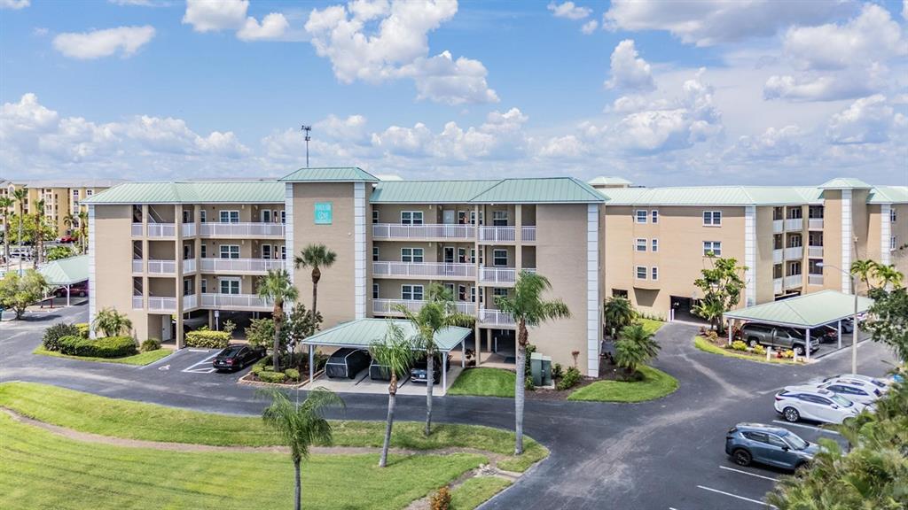 399 150th Avenue, Unit 315 Madeira Beach, FL 33708 - Photo 52 of 53 a front view of building with outdoor seating