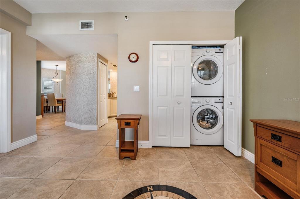 399 150th Avenue, Unit 315 Madeira Beach, FL 33708 - Photo 6 of 53 a view of a storage and utility room with washer and dryer