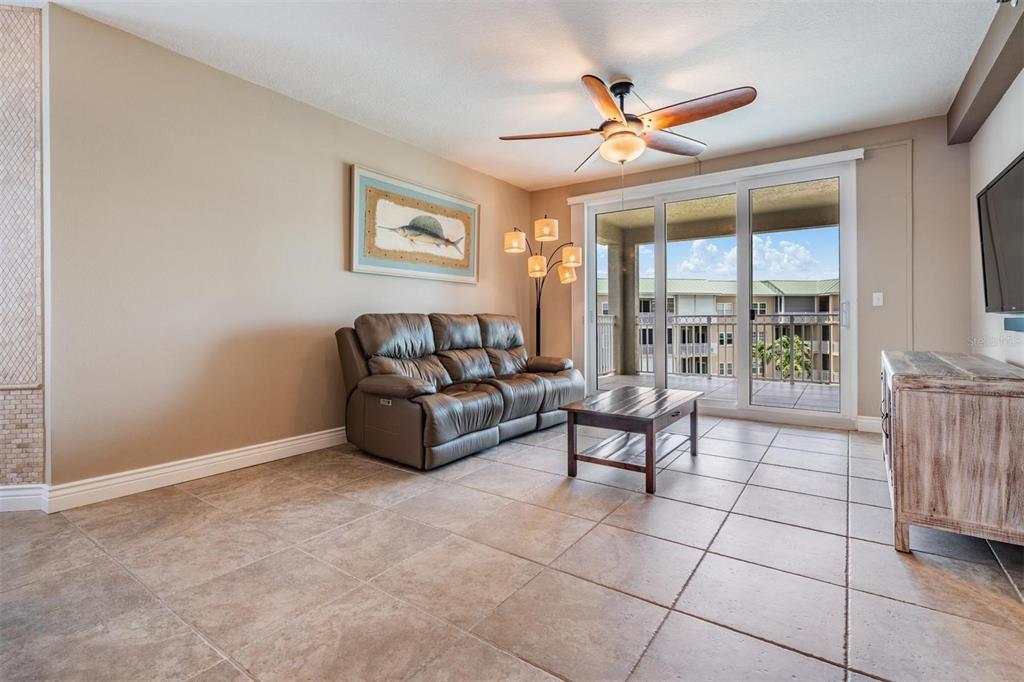 399 150th Avenue, Unit 315 Madeira Beach, FL 33708 - Photo 10 of 53 a living room with furniture and a ceiling fan