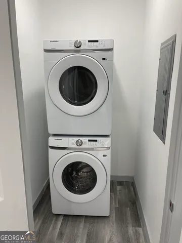 a view of a hallway with wooden floor and staircase