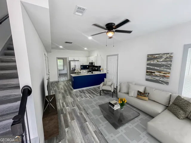 a living room with furniture and a chandelier