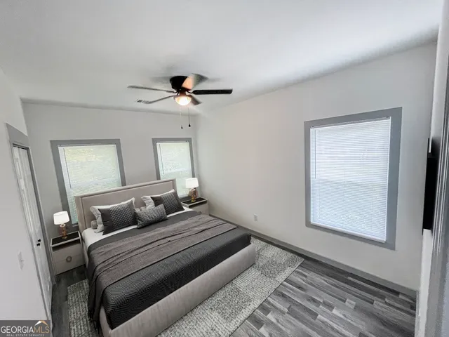 a bedroom with a large bed and a window