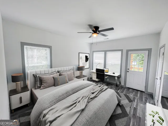 a bedroom with a bed window and a flat screen tv