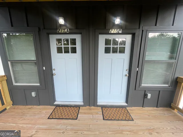 a view of a a dining room with furniture window and wooden floor