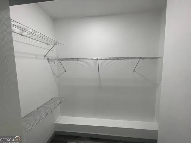 a view of storage and utility room with racks on the wall