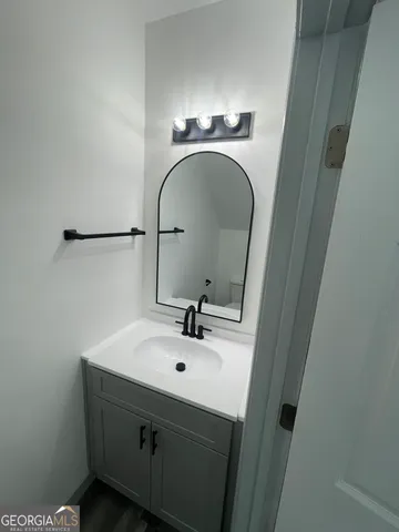 a white toilet sitting next to a white wall