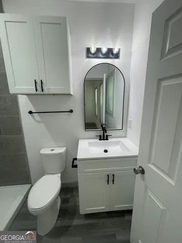 a bathroom with a toilet and a shower