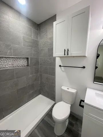 a bathroom with a shower and toilet