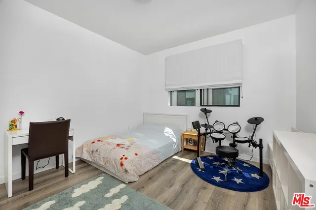 a bed room with furniture and a chair