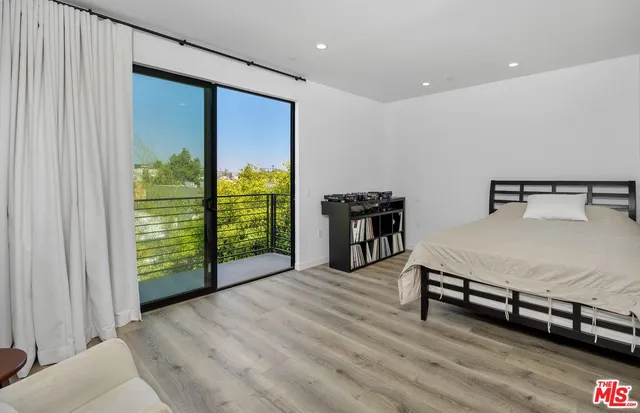 a spacious bedroom with a bed and a window