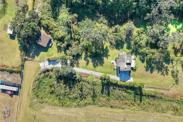 a view of yard with swimming pool and trees