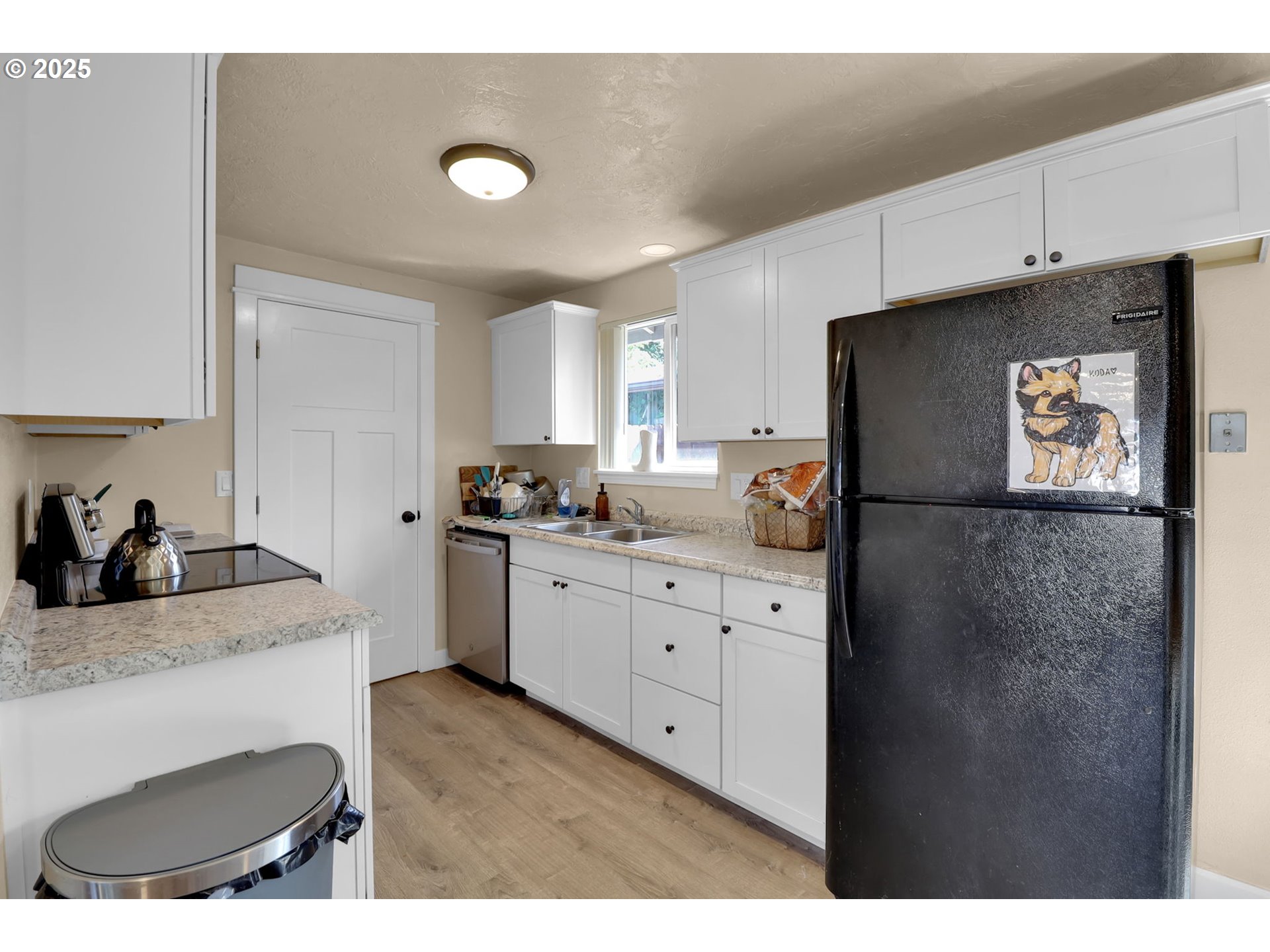 495 52nd Street Springfield, OR 97478 - Photo 8 of 38 a kitchen with granite countertop a refrigerator sink and white cabinets