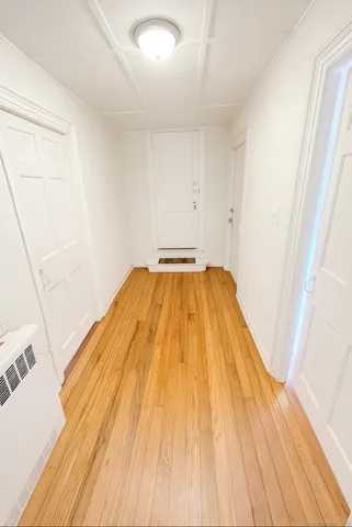 a view of a hardwood floor in a room