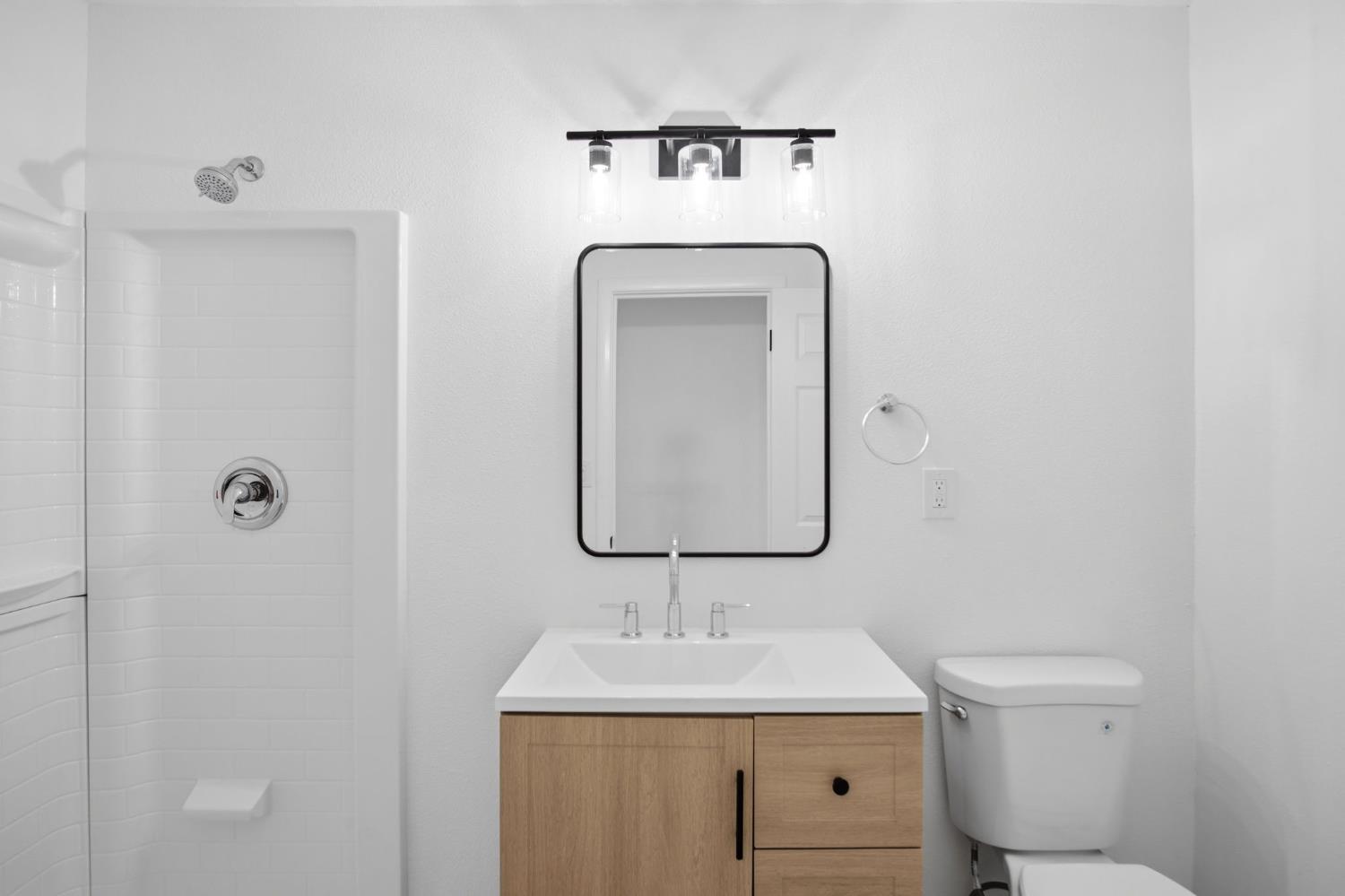 1451 Kent Way Modesto, CA 95355 - Photo 17 of 37 a bathroom with a toilet sink and mirror