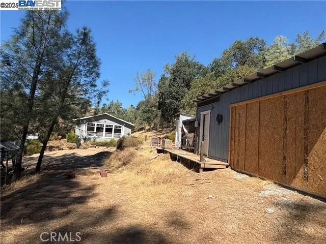 a view of a house with backyard and sitting area