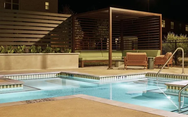 a view of a swimming pool with outdoor seating