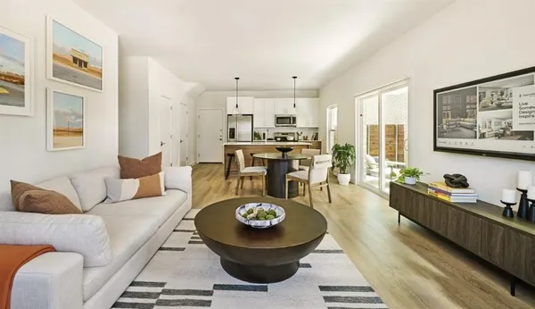 a living room with furniture and kitchen view