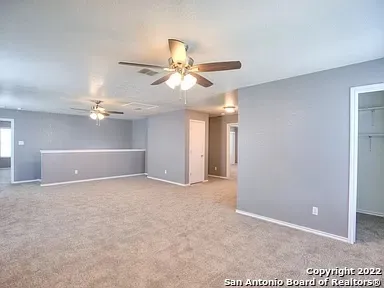 a view of a room with a ceiling fan and a chandelier fan