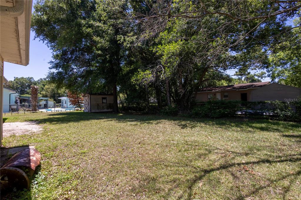 6281 Southeast Hames Road Belleview, FL 34420 - Photo 12 of 16 a view of pool with lawn chairs and plants