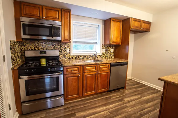 a stove top oven sitting inside of a kitchen