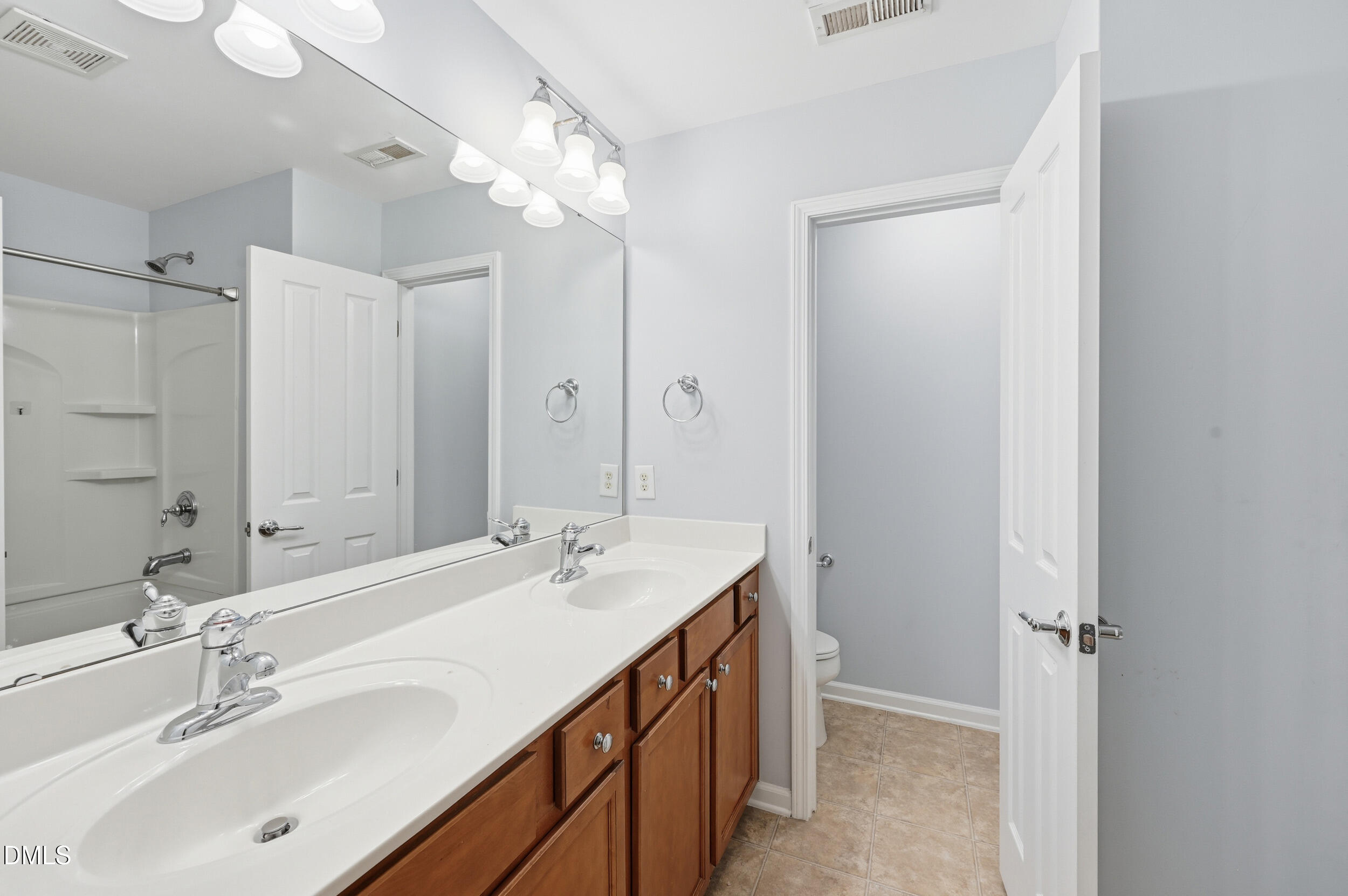 8412 Pilots View Drive Raleigh, NC 27617 - Photo 22 of 40 a bathroom with a double vanity sink mirror and double
