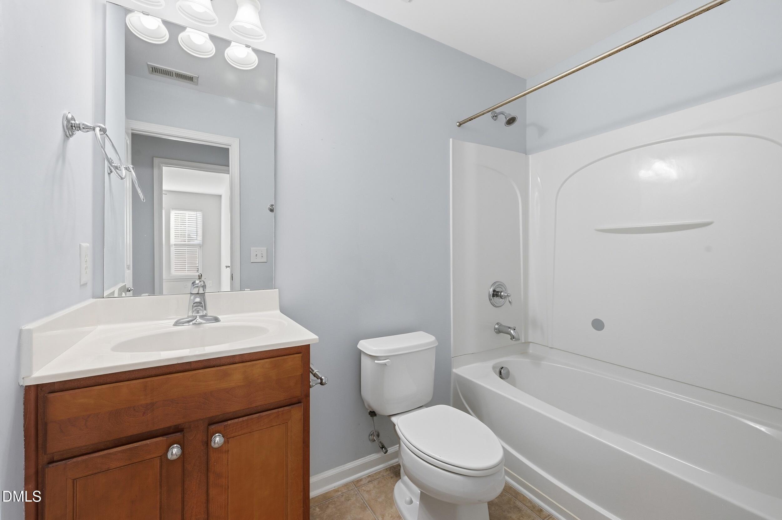 8412 Pilots View Drive Raleigh, NC 27617 - Photo 28 of 40 a bathroom with a sink a toilet and shower