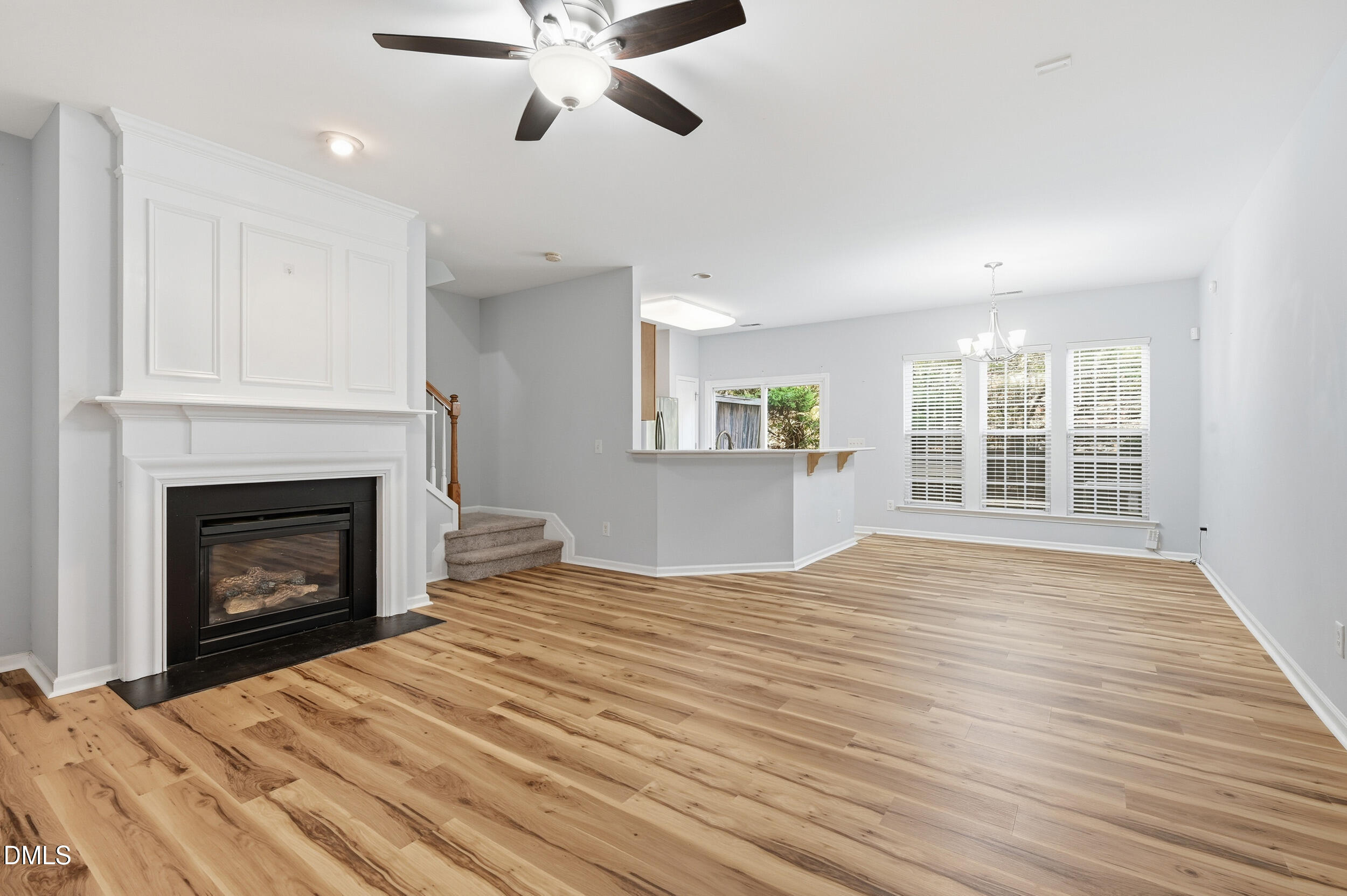 8412 Pilots View Drive Raleigh, NC 27617 - Photo 7 of 40 a view of an empty room with wooden floor fireplace and a window