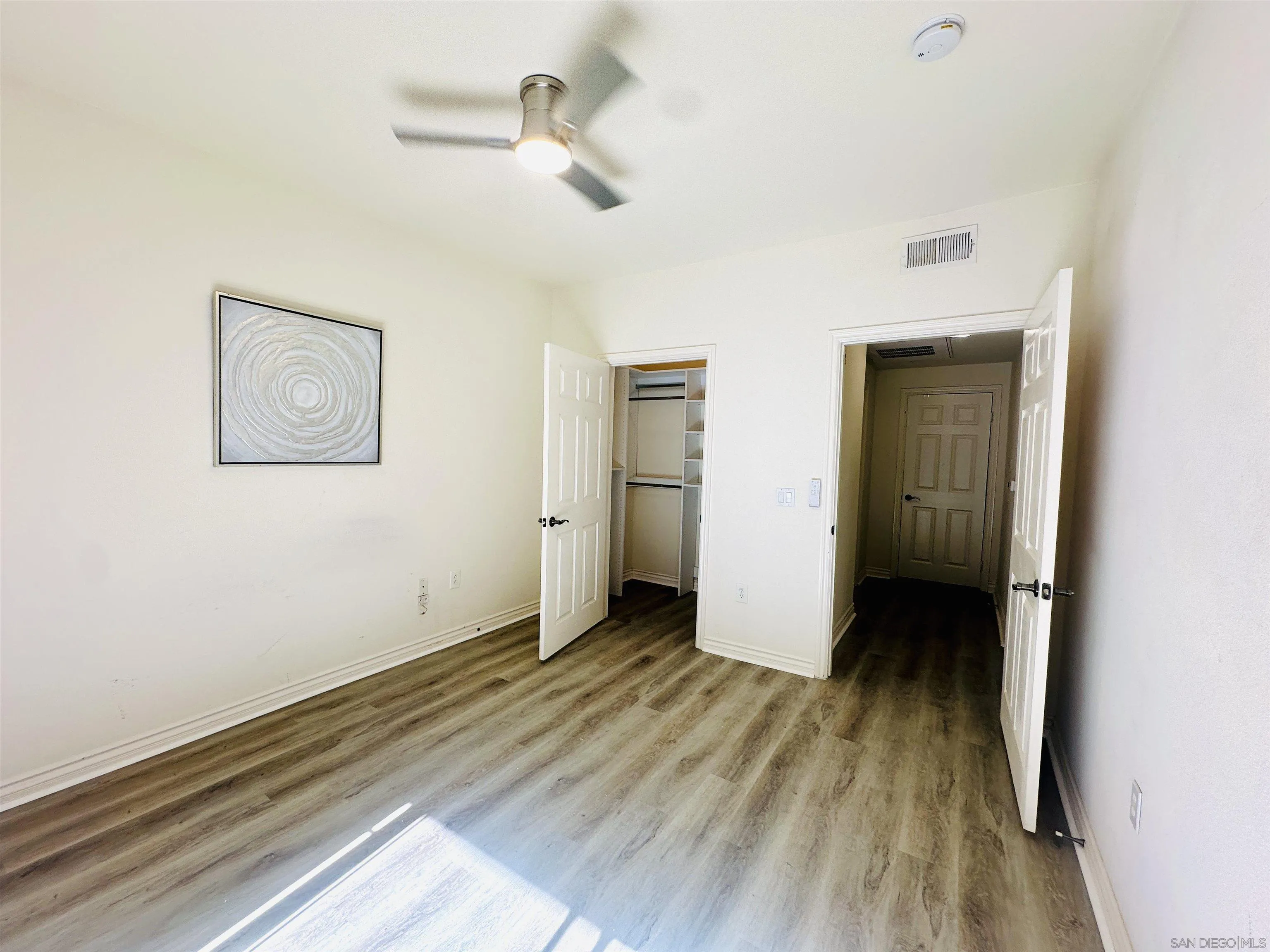 9263 Regents Road, Unit B204 La Jolla, CA 92037 - Photo 9 of 17 a view of an empty room with wooden floor