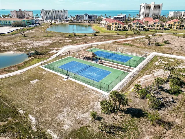 a view of building with tub and car parked