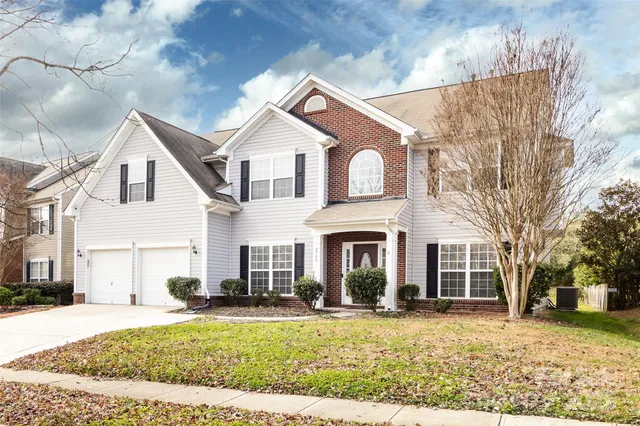 a front view of a house with a yard