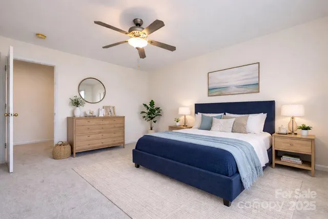 a bedroom with a bed a chandelier and dresser