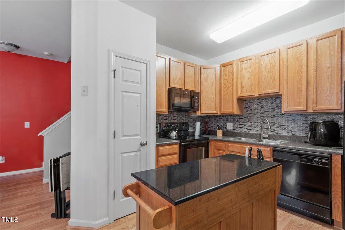300 Gilman Lane, Unit 101 Raleigh, NC 27610 - Photo 12 of 25 a kitchen with stainless steel appliances granite countertop a sink stove and refrigerator