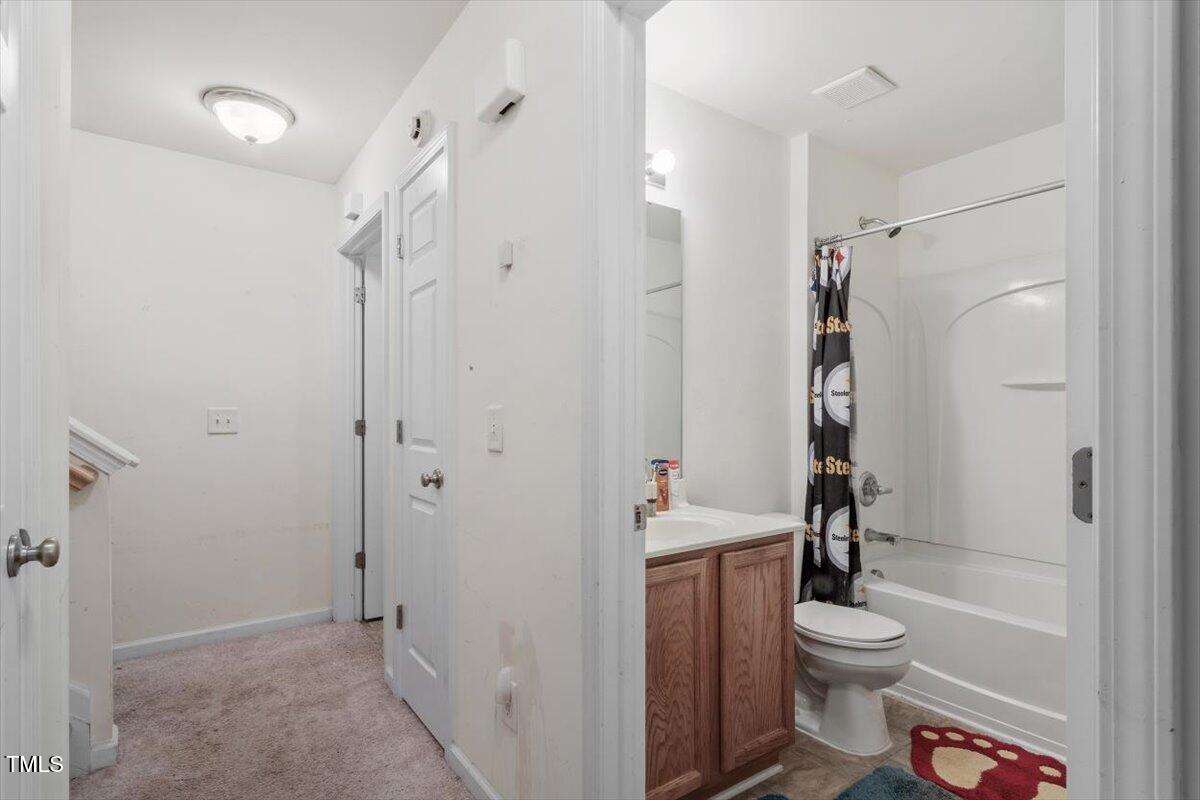 300 Gilman Lane, Unit 101 Raleigh, NC 27610 - Photo 14 of 25 a bathroom with a toilet a sink and shower