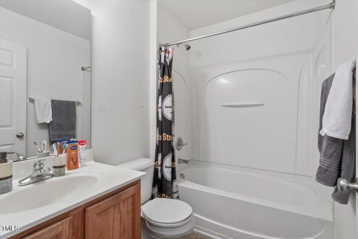 300 Gilman Lane, Unit 101 Raleigh, NC 27610 - Photo 15 of 25 a bathroom with a sink toilet and shower