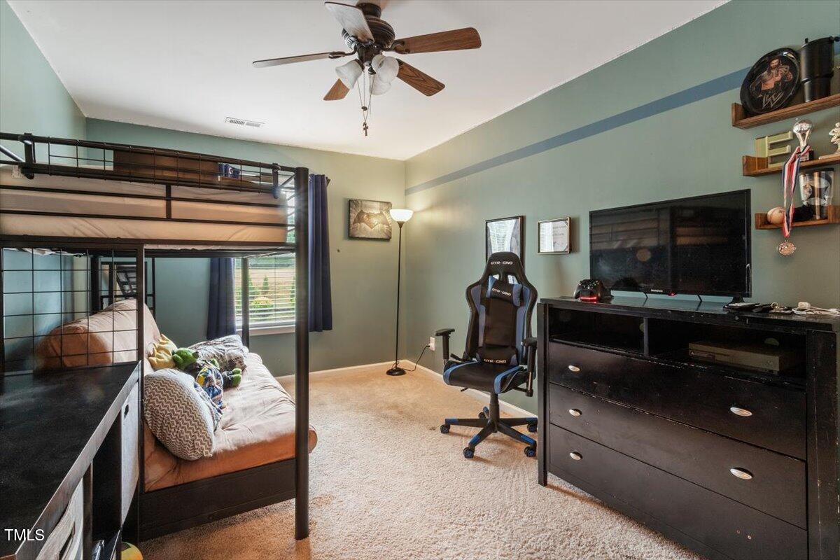 300 Gilman Lane, Unit 101 Raleigh, NC 27610 - Photo 18 of 25 a view of a livingroom with furniture and a flat screen tv