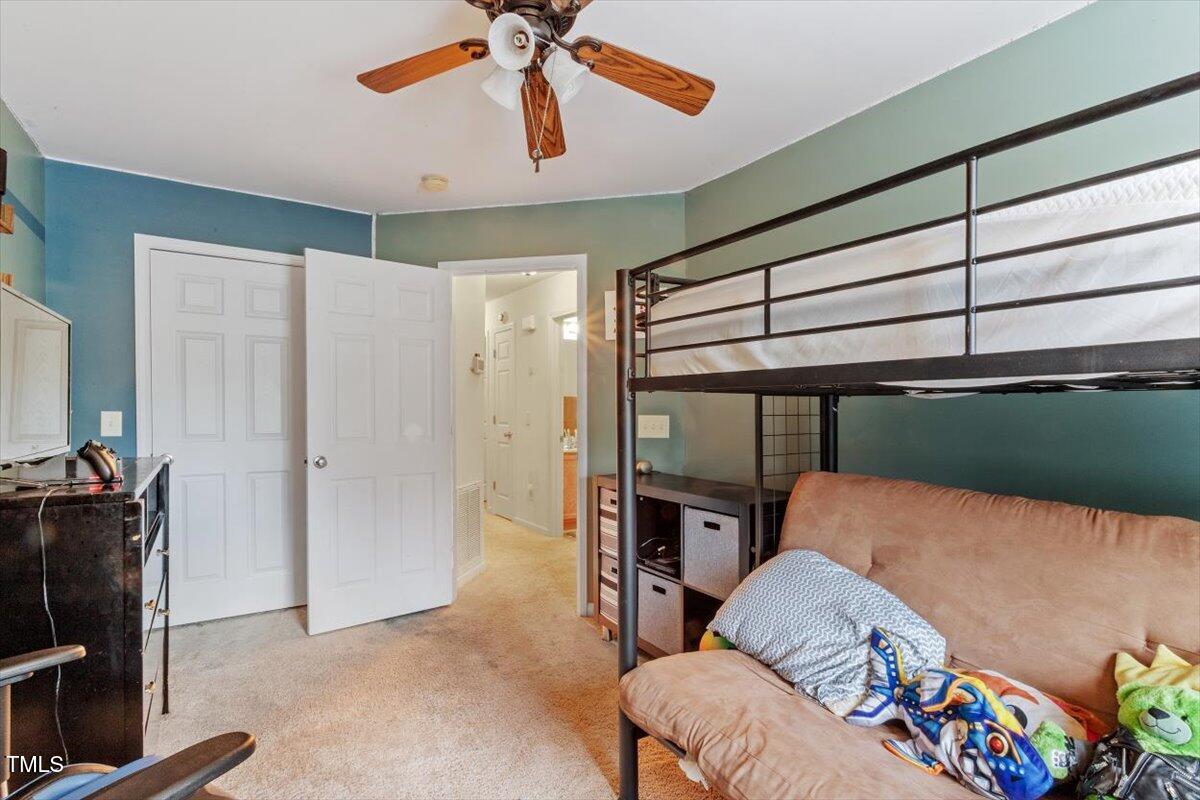 300 Gilman Lane, Unit 101 Raleigh, NC 27610 - Photo 19 of 25 a bedroom with furniture and a ceiling fan